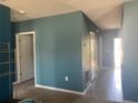 Hallway with neutral paint and tile flooring that gives access to other rooms at 1707 Ambar Ct, Winter Haven, FL 33881