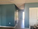 Hallway with ceramic tile flooring and neutral paint leading to the front entrance at 1707 Ambar Ct, Winter Haven, FL 33881
