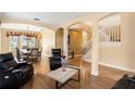 Open-concept living space with archways, a staircase, hardwood flooring, and a dining area view at 2020 Windcrest Lake Cir, Orlando, FL 32824
