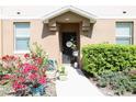Charming townhouse front door with a lovely landscaped entrance, plants, and welcoming decor at 2120 Betsy Ross Ln, St Cloud, FL 34769