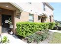 Inviting townhome entrance with door decor and manicured bushes at 2120 Betsy Ross Ln, St Cloud, FL 34769