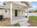Covered back porch with steps leading down to the yard, providing a cozy outdoor space at 2237 Avenue B Nw, Winter Haven, FL 33880
