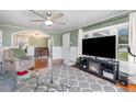 Cozy living room with a fireplace, comfortable seating, and hardwood floors under a ceiling fan at 2237 Avenue B Nw, Winter Haven, FL 33880