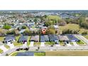 Aerial view of a neighborhood with tree-lined streets and well-maintained homes near a lake at 2461 Bulrush Dr, St Cloud, FL 34769