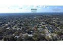 Expansive aerial view showcasing the neighborhood's mature trees, proximity to Winter Park and Orlando at 2654 Derbyshire Rd, Maitland, FL 32751