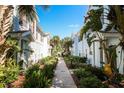 Charming walkway surrounded by lush greenery and tropical plants leading through well-maintained townhome community at 2962 Lucayan Harbour Cir # 102, Kissimmee, FL 34746