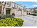 Charming townhome featuring attached garages and well-manicured bushes at 3008 Thornton Dr, Kissimmee, FL 34741