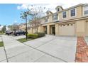 Inviting townhome with well-maintained landscaping, private balconies, and attached garages at 3008 Thornton Dr, Kissimmee, FL 34741