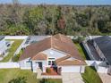 Aerial view of a home featuring a backyard pool, surrounded by a privacy fence and lush greenery at 3123 Fairfield Dr, Kissimmee, FL 34743