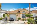 Inviting single-story home with a well-manicured front yard and an attached one-car garage at 3233 Brewster Dr, Kissimmee, FL 34743