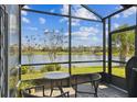 Screened lanai with seating and a view of the community lake at 3384 Fallbrook Dr, Poinciana, FL 34759