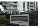 A sign for Park Lake Towers Condominium with visitor parking under an awning with plants surrounding the sign at 400 E Colonial Dr # 1504, Orlando, FL 32803