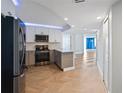 Modern kitchen featuring stainless steel appliances, light gray cabinets, and herringbone wood flooring at 400 E Colonial Dr # 1504, Orlando, FL 32803