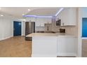 Contemporary kitchen showcasing white cabinets, stainless steel appliances, and a sleek countertop island at 400 E Colonial Dr # 1504, Orlando, FL 32803