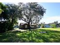 Lush backyard with mature trees providing shade and character to the property at 4235 W Vista Ct, Kissimmee, FL 34746