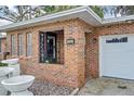 Close up of front brick entrance with welcome sign, and double garage doors at 4884 Meadow Dr, St Cloud, FL 34772