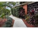 Inviting front yard showcasing the home's landscape design with vibrant plants and a paved walkway at 5019 Saint Germain Ave, Orlando, FL 32812