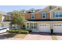 Charming townhome with a brick driveway and a one-car garage at 521 Pacito Way, St Cloud, FL 34769
