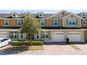 Charming townhome with a brick driveway and a one-car garage at 521 Pacito Way, St Cloud, FL 34769