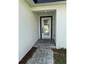 Close-up of the front door featuring a glass window with a black frame at 6 Bahia Course Ln, Ocala, FL 34472