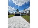 Inviting single-story home with a spacious driveway, two-car garage, and green grass at 6 Bahia Course Ln, Ocala, FL 34472