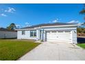 Charming single-story home featuring a wide driveway, two-car garage, and well-maintained lawn at 603 Amazon Pl, Kissimmee, FL 34759