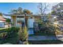 Charming home featuring a well-kept lawn, cozy porch, and an inviting entrance at 615 N Emory Ave, Kissimmee, FL 34741