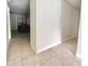 Bright hallway with tile flooring leading to a living room area at 616 N Palm Ave, Kissimmee, FL 34741