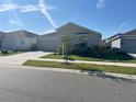 Charming single-story home featuring a well-manicured lawn and a two-car garage at 676 Tanaro Ln, Haines City, FL 33844