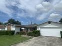 Charming single-story home features a brick accent, well-manicured lawn, and attached garage at 706 Francis St, Kissimmee, FL 34741