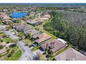Real estate aerial showing a neighborhood with a serene lake and lush greenery at 741 Villa Park Rd, Poinciana, FL 34759