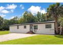 Single-story home with brick driveway, showcasing the home's facade and well-manicured lawn at 78 N 5Th St, Orlando, FL 32833