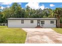 Charming single-story home with a spacious brick driveway and well-maintained landscaping at 78 N 5Th St, Orlando, FL 32833