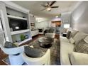 Open-concept living room with a modern design, including a sofa, chairs, and entertainment center at 8300 Elm Park Dr # 7110, Orlando, FL 32821