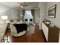 Comfortable living room with hardwood floors, stylish furniture, and natural light from the sliding door at 8300 Elm Park Dr # 7110, Orlando, FL 32821