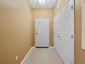 Bright entryway with neutral paint, tiled floor, and a closet near the front door at 8300 Portofino Dr # 403, Davenport, FL 33896