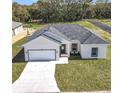 Well-maintained single-Gathering home with two-car garage and green lawn at 110 Alta Vista Way, Davenport, FL 33837