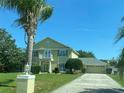 Two-story home showcasing manicured lawn, attached garage, and a private balcony on the facade at 1201 Providence Blvd, Kissimmee, FL 34744