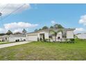 Beautiful single-story home with a manicured lawn and a spacious driveway leading to a garage at 151 Flatfish Ct, Poinciana, FL 34759