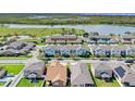 Aerial view of townhomes near a lake with green spaces and community amenities at 1578 Softshell St, St Cloud, FL 34771