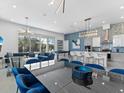 A well lit living room with a kitchen, dining area, and a billiard table, perfect for entertaining at 2117 Pine Oak Loop, Davenport, FL 33837