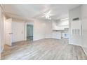 Open living room with neutral walls, wood floors, and a ceiling fan at 2210 Yankee Pl # 334, Orlando, FL 32839