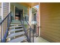 View of the stairwell with black metal railings, and multiple condo entrances at 2210 Yankee Pl # 334, Orlando, FL 32839