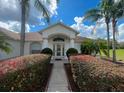 Inviting front entrance with lush landscaping, creating a warm and welcoming path to the home's front door at 24 Cordona Dr, Kissimmee, FL 34758