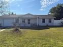 Attractive single story home with well maintained lawn, white picket fence, and attached garage at 268 Florida Pkwy, Kissimmee, FL 34743