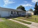 Exterior view of house with driveway and detached garage at 268 Florida Pkwy, Kissimmee, FL 34743