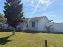 Side view of house with well-maintained lawn and privacy fence at 268 Florida Pkwy, Kissimmee, FL 34743