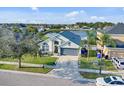 Aerial shot of a single-story home with a view of a serene lake at 3686 Ricky Ln, St Cloud, FL 34772