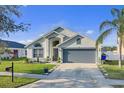 Well-maintained single-story home with a two-car garage and verdant front yard at 3686 Ricky Ln, St Cloud, FL 34772