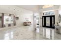 Open-concept foyer with elegant marble flooring and bright natural light at 4301 Presidio Way, Kissimmee, FL 34746